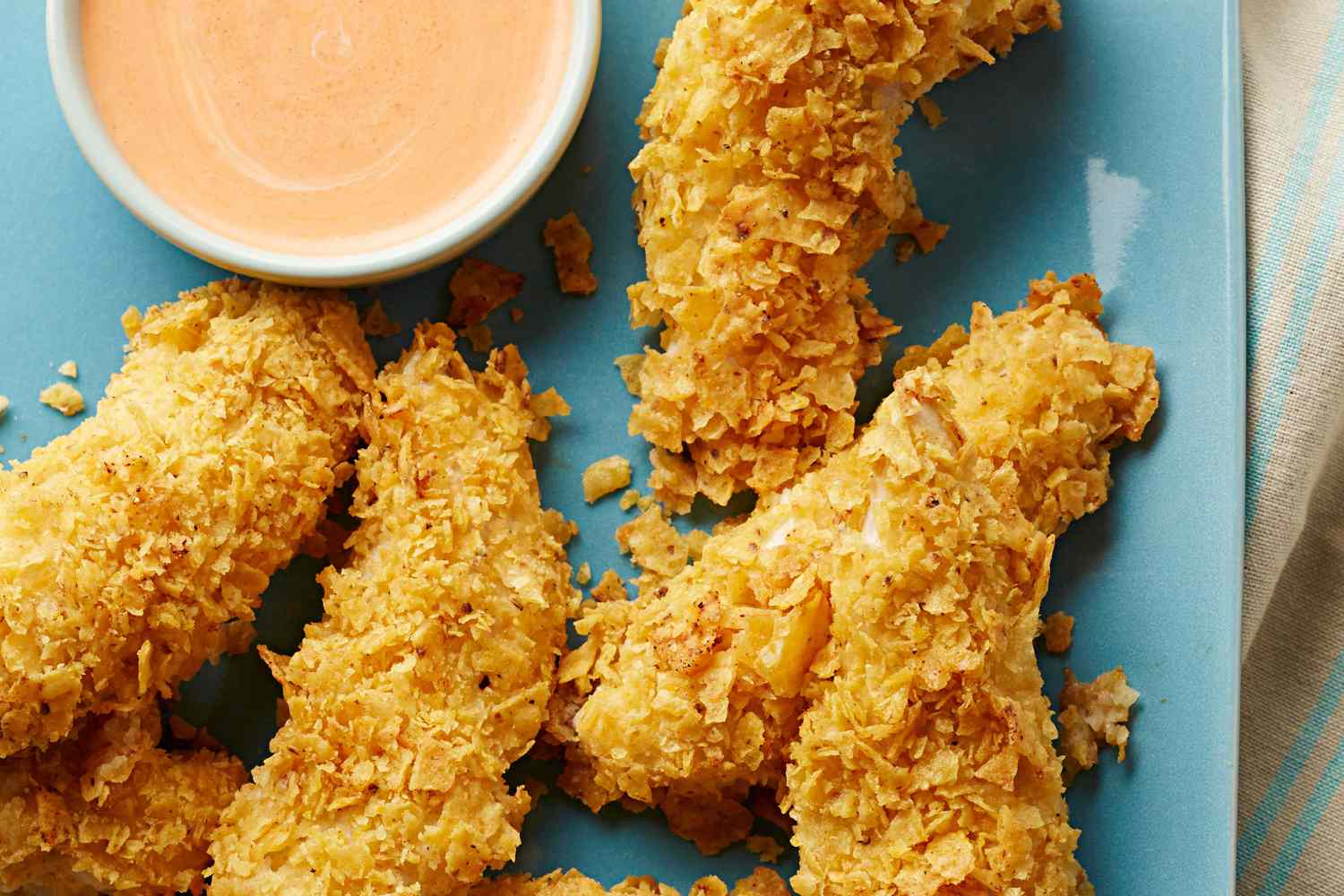 Smoky Corn Chip Crusted Chicken Tenders coated in crushed Sweet & Smokey Pepper Mitten Chips